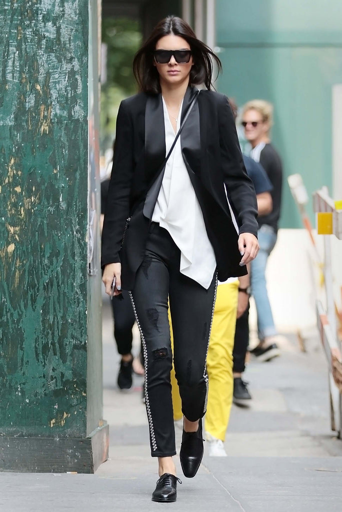 KENDALL JENNER in black distressed Etienne Marcel jeans with studded detailing.